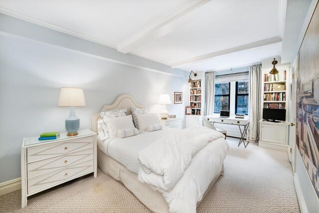 carpeted bedroom featuring beamed ceiling