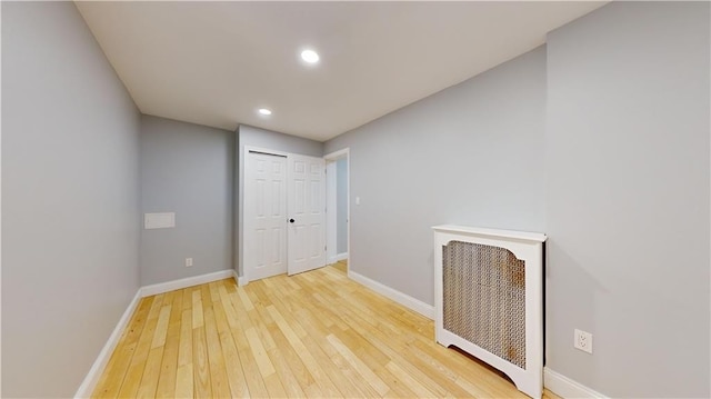 empty room featuring recessed lighting, light wood-style flooring, and baseboards