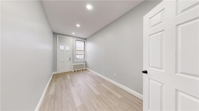 unfurnished room featuring light wood finished floors, recessed lighting, and baseboards