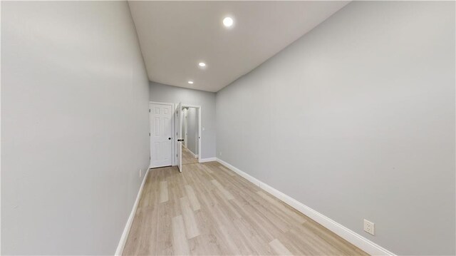 hall featuring recessed lighting, baseboards, and light wood-type flooring