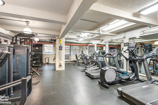 gym featuring brick wall