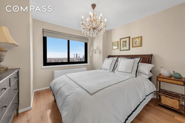 bedroom featuring light wood-style flooring and baseboards