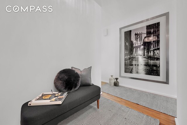 living area featuring baseboards and wood finished floors