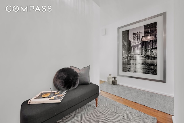 living area with wood finished floors and baseboards