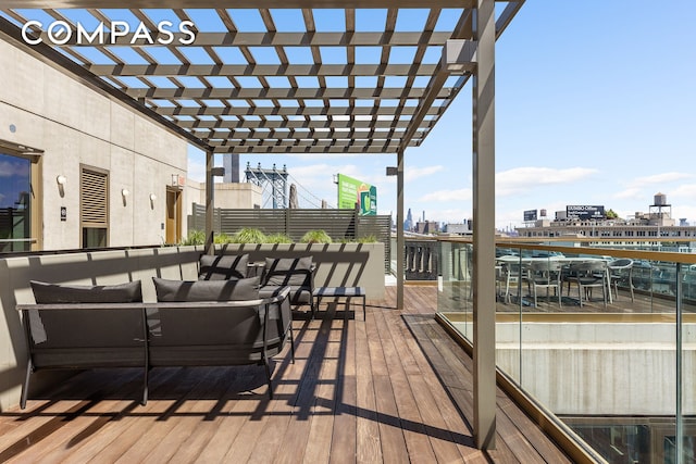 wooden deck with an outdoor living space, a view of city, and a pergola