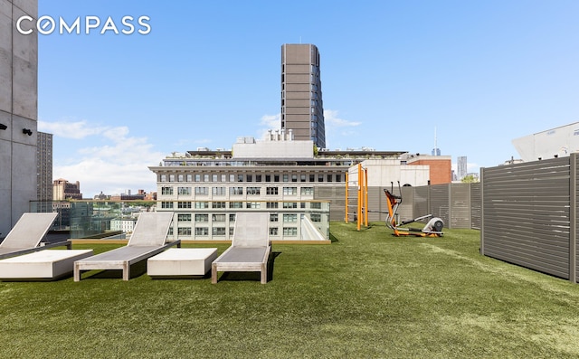 back of property featuring a view of city and a lawn