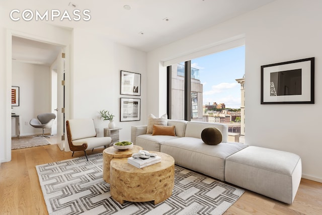 living area with baseboards and light wood finished floors