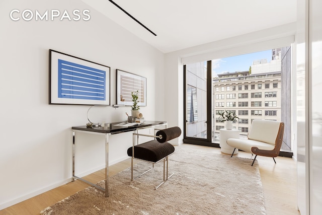 office space featuring baseboards and wood finished floors