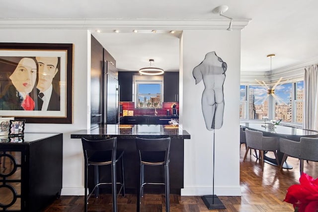 bar featuring dark parquet flooring, plenty of natural light, sink, and crown molding