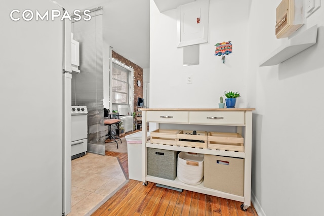 kitchen featuring white cabinetry, white appliances, and light wood-type flooring