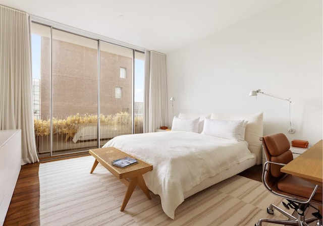 bedroom featuring wood-type flooring and floor to ceiling windows