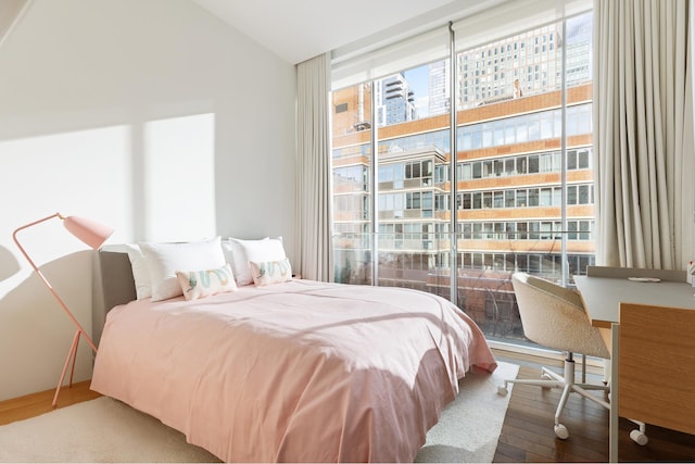 527 W 27th St Unit 9A, New York City, NY 10001 - bedroom featuring wood finished floors, expansive windows, and lofted ceiling