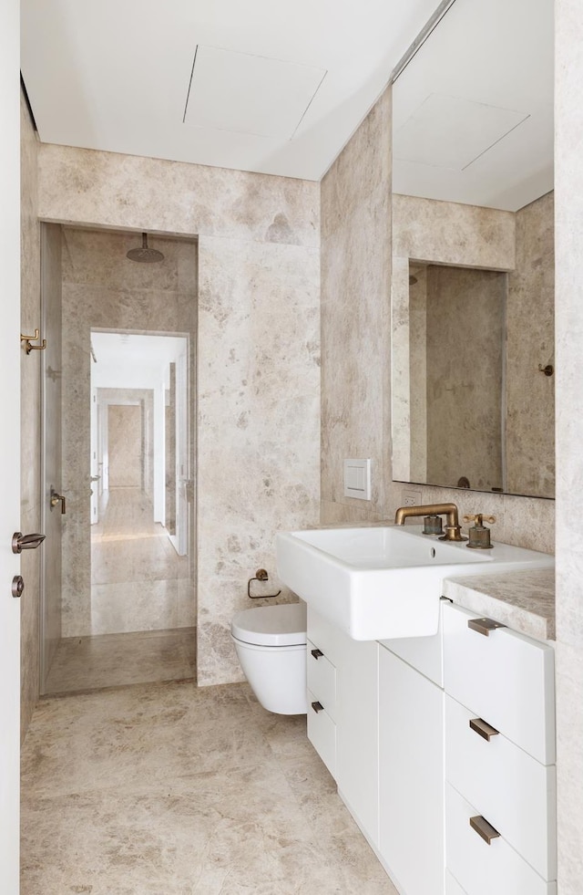 bathroom featuring tile walls, walk in shower, toilet, and vanity