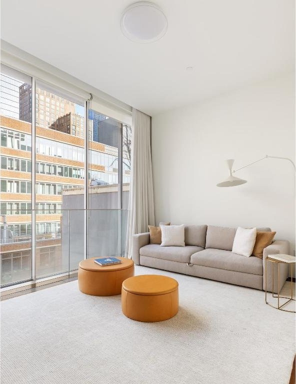 carpeted living room with floor to ceiling windows