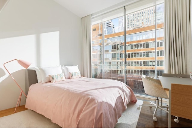 bedroom featuring vaulted ceiling and hardwood / wood-style flooring