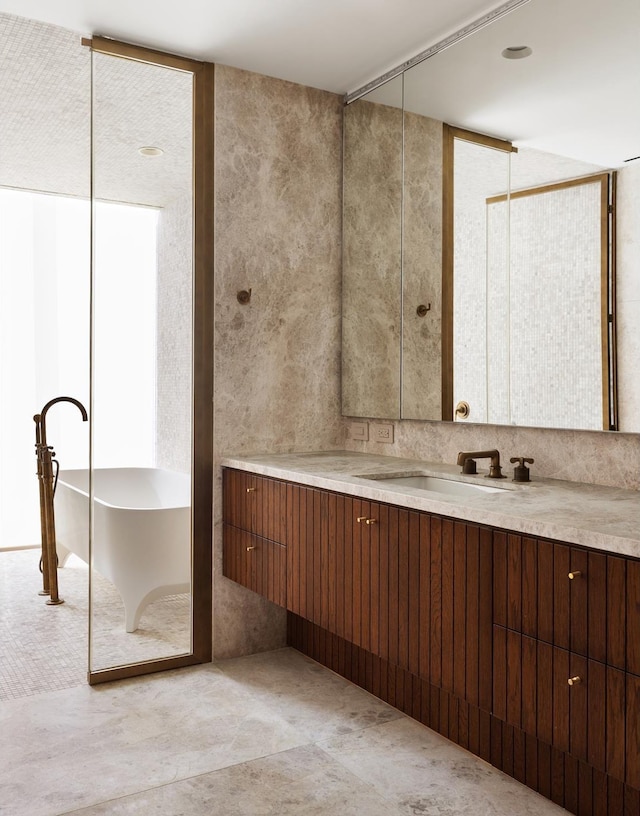 bathroom featuring vanity and a freestanding bath