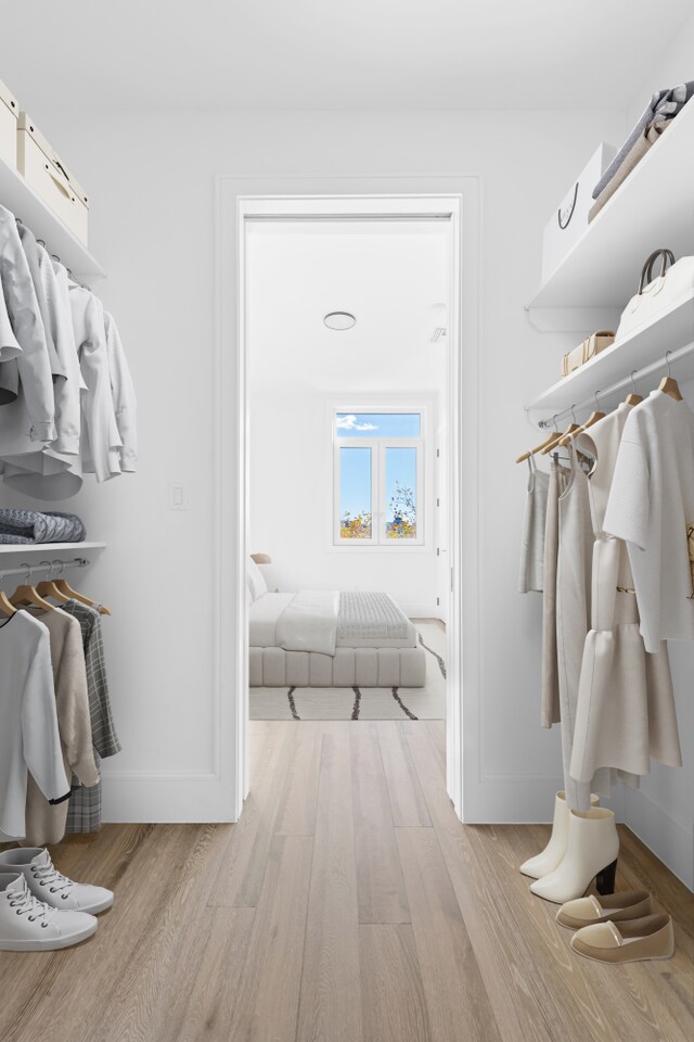 spacious closet featuring light hardwood / wood-style flooring