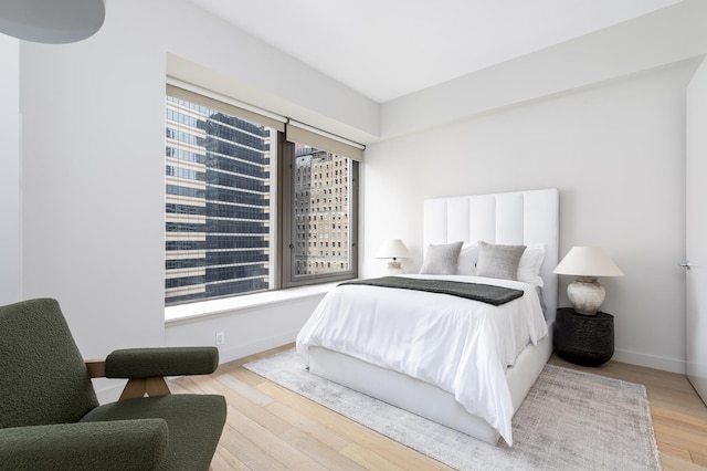 bedroom featuring wood finished floors and baseboards