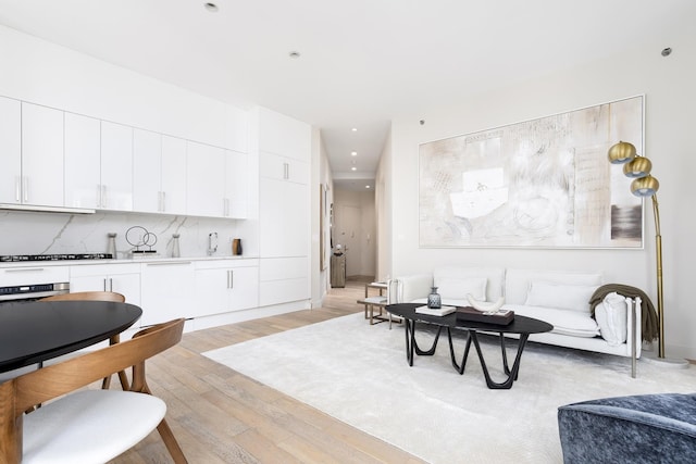 living room featuring light wood-type flooring and recessed lighting