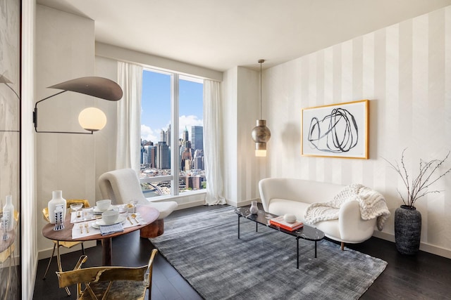 living area featuring baseboards, a city view, and wood finished floors