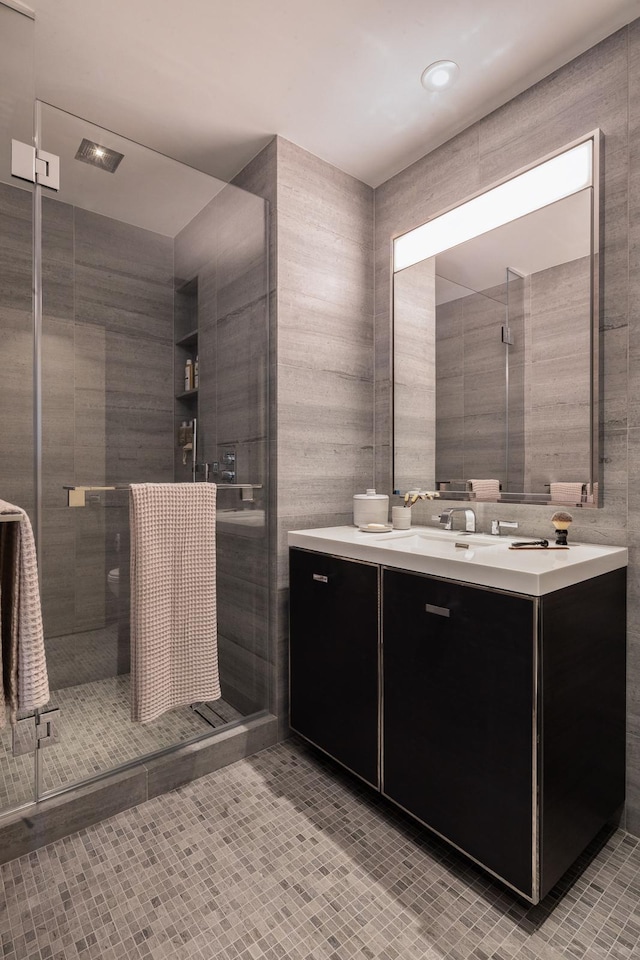 252 S St Unit 66B, New York City, NY 10002 - full bathroom with a stall shower, vanity, tile patterned floors, and tile walls