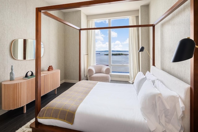 252 S St Unit 66B, New York City, NY 10002 - bedroom with wood finished floors, wallpapered walls, a water view, and baseboards