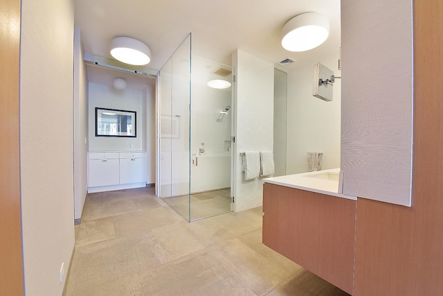 full bathroom featuring visible vents, vanity, and a shower