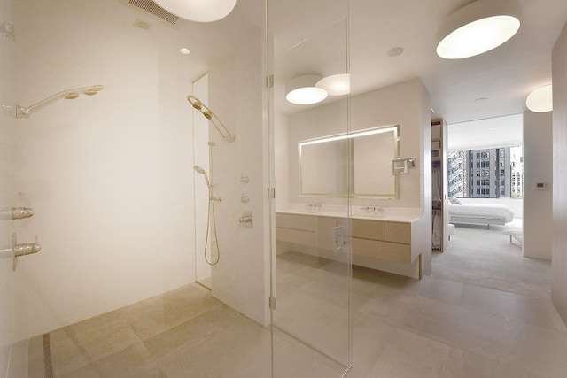 ensuite bathroom featuring visible vents, walk in shower, ensuite bathroom, tile patterned floors, and vanity