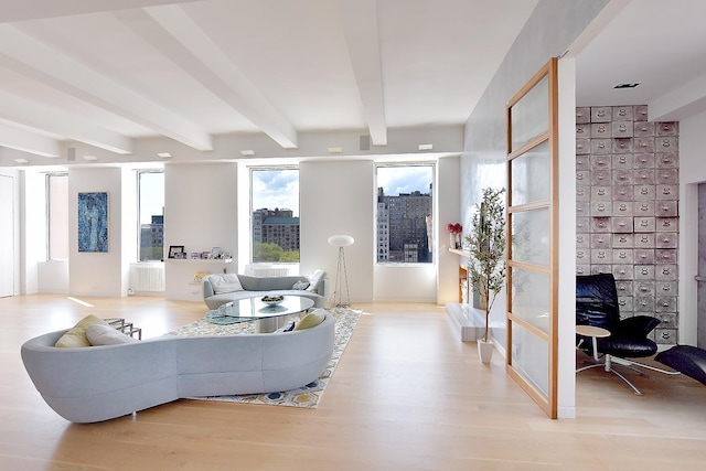 living room with beam ceiling and light wood-style flooring