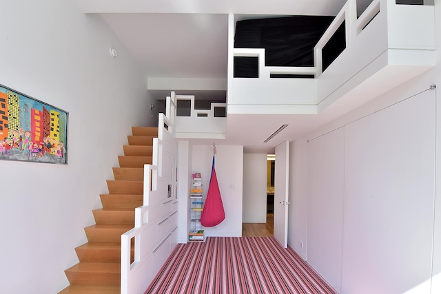 staircase featuring wood finished floors