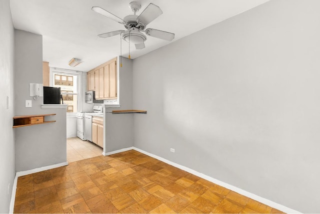 kitchen with light parquet flooring, black fridge, ceiling fan, and gas range gas stove