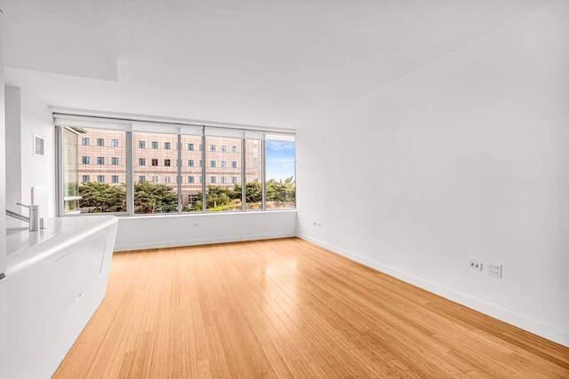 empty room with light hardwood / wood-style floors