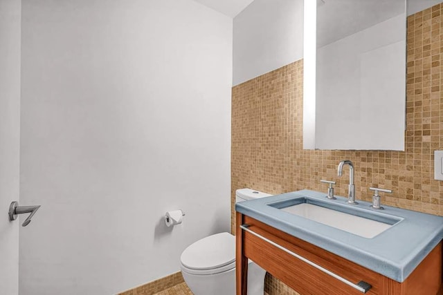 full bathroom featuring tile walls, sink, tiled shower / bath combo, and toilet