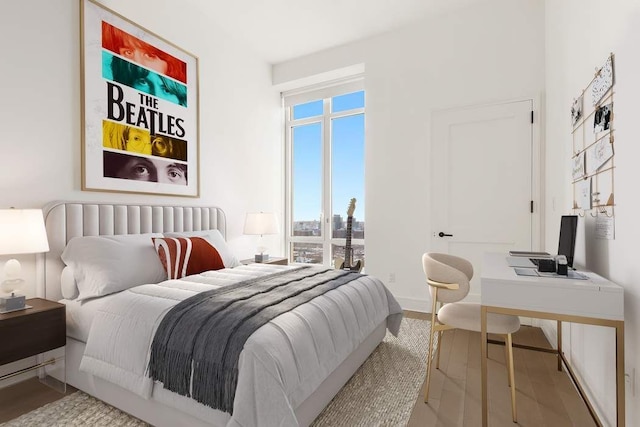 bedroom with hardwood / wood-style flooring