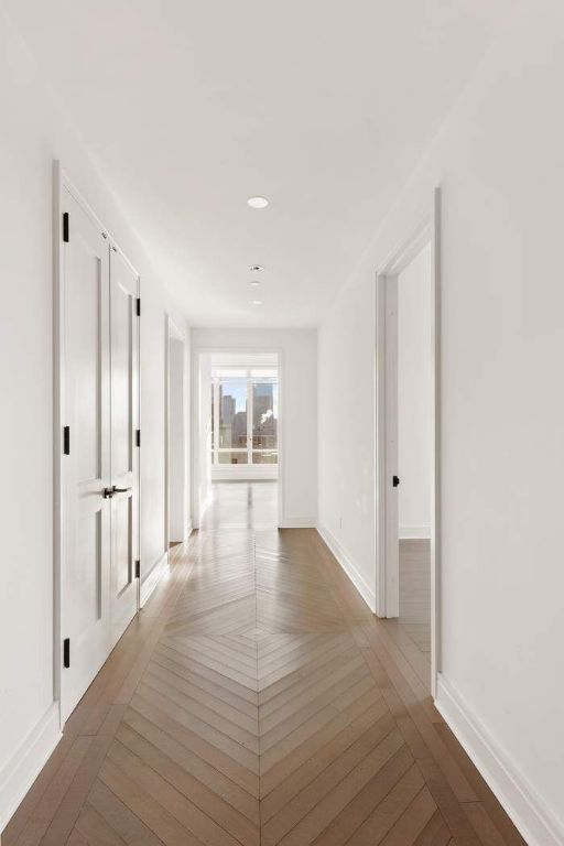 hallway with hardwood / wood-style floors