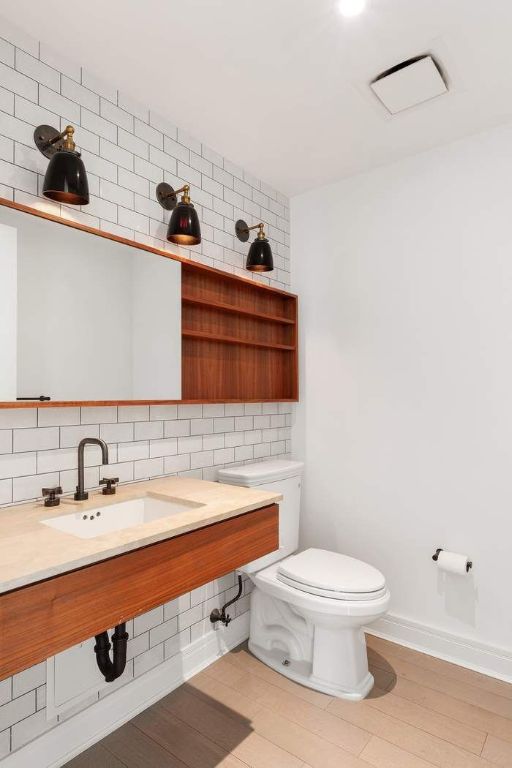 bathroom with tasteful backsplash, sink, and toilet