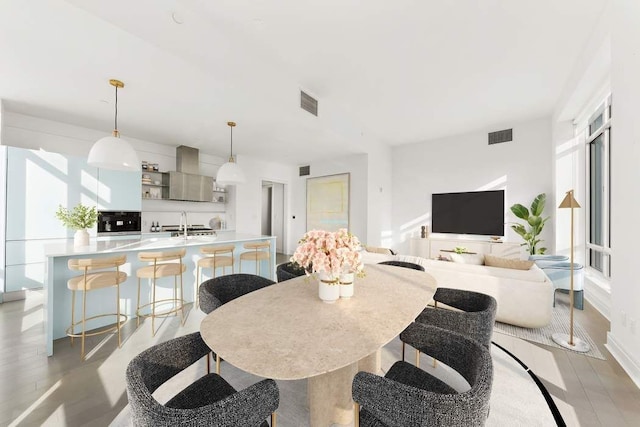 dining space with light hardwood / wood-style floors