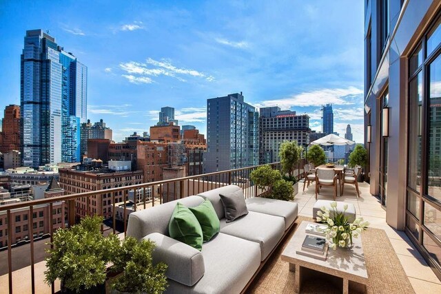 balcony featuring an outdoor living space and a patio area