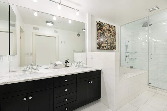 28 Laight St Unit 6Ab, New York City, NY 10013 - bathroom with vanity, tile patterned flooring, plus walk in shower, and tile walls