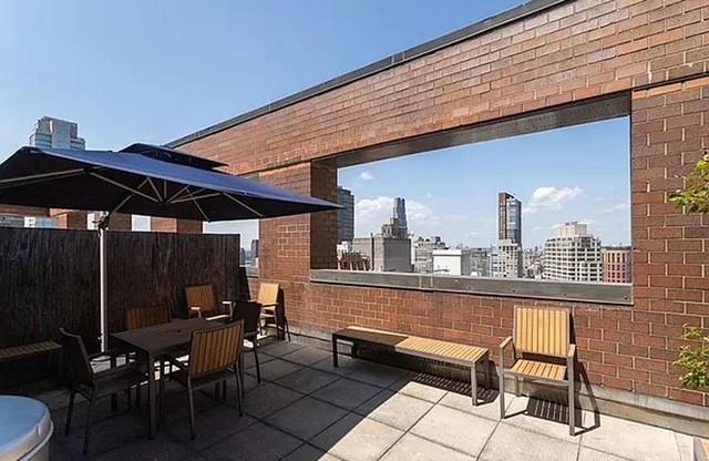 view of patio featuring outdoor dining space, a view of city, and fence