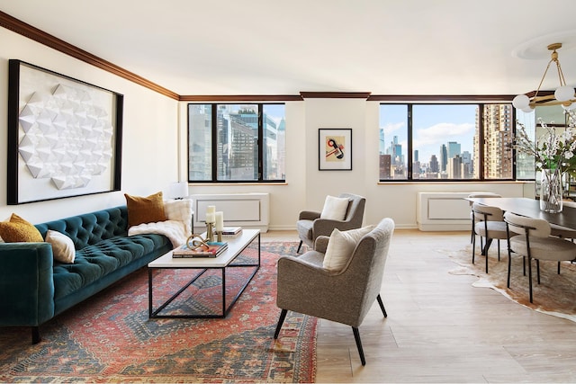 living room with a city view, crown molding, light wood-style flooring, and a notable chandelier