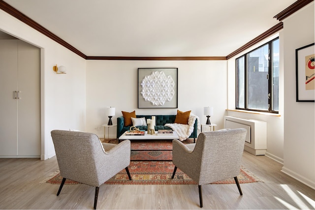 living room with light wood-style floors, crown molding, and baseboards