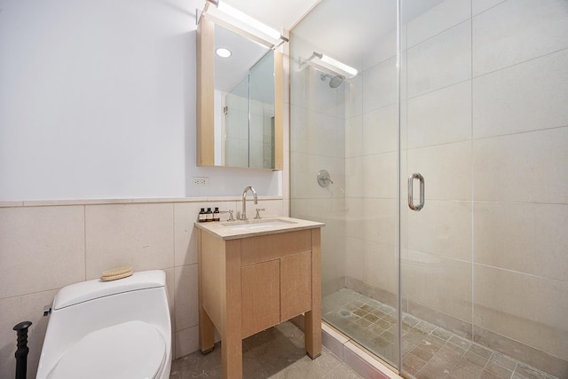 full bath with tile walls, a stall shower, toilet, and vanity