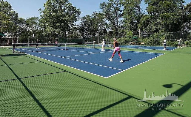 view of sport court featuring fence