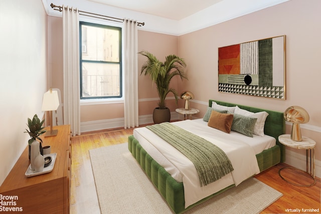 bedroom featuring baseboards and wood finished floors