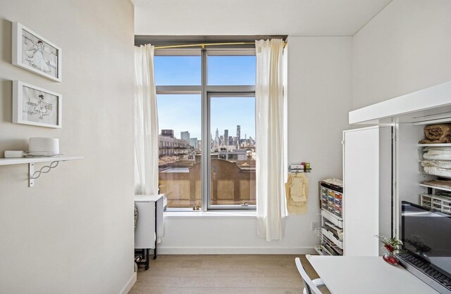 home office with light hardwood / wood-style floors