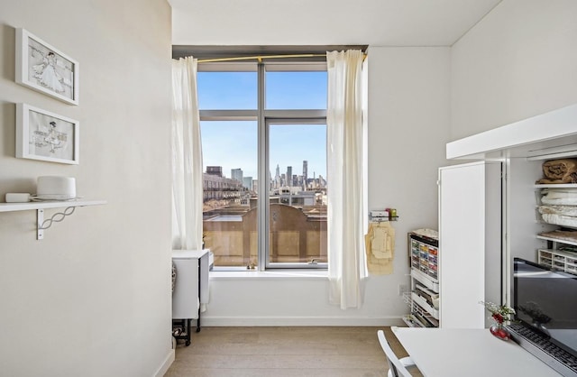 interior space with light wood-type flooring and baseboards