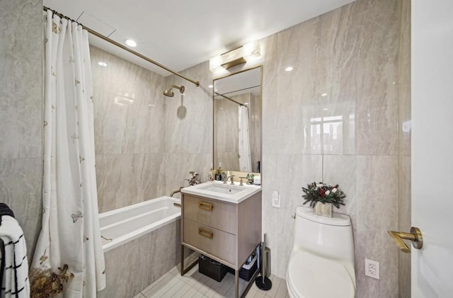 full bathroom featuring shower / bath combination with curtain, toilet, tile patterned flooring, and tile walls