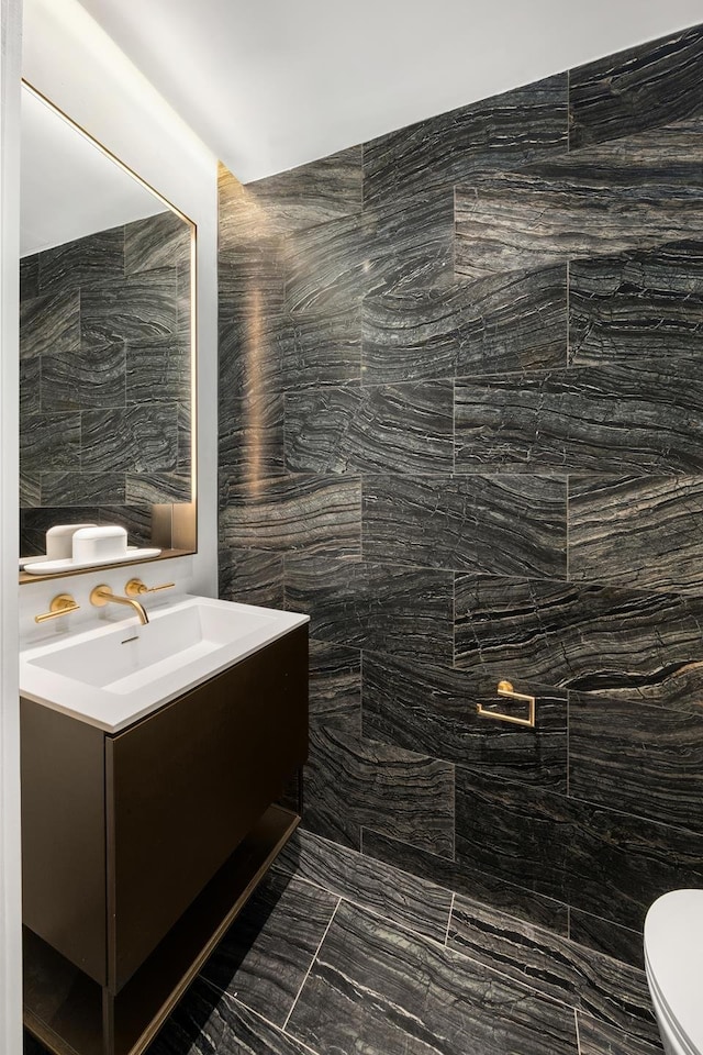 bathroom featuring marble finish floor, toilet, and vanity