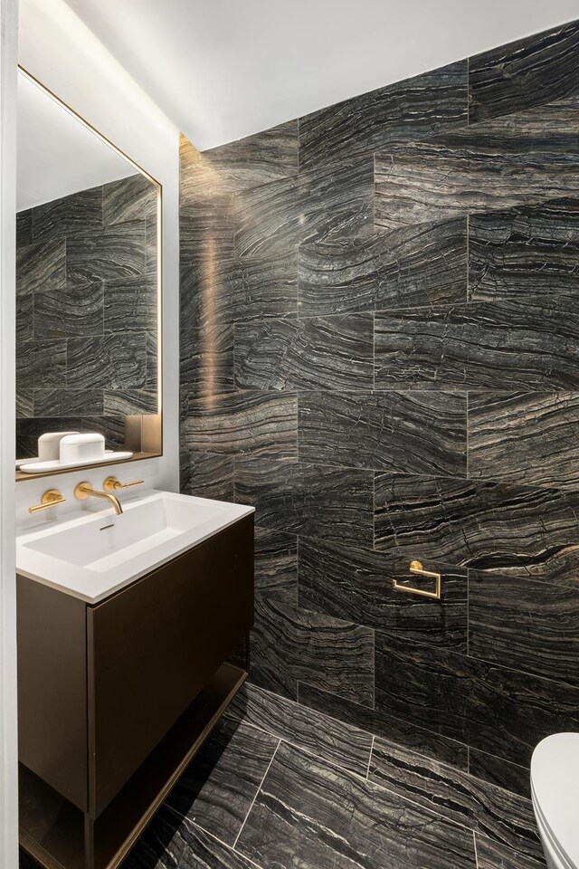 215 W 28th St Unit 2C, New York City, NY 10001 - bathroom with toilet, vanity, and marble look tile flooring
